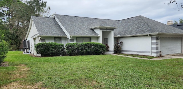 view of front of house with a front yard and a garage