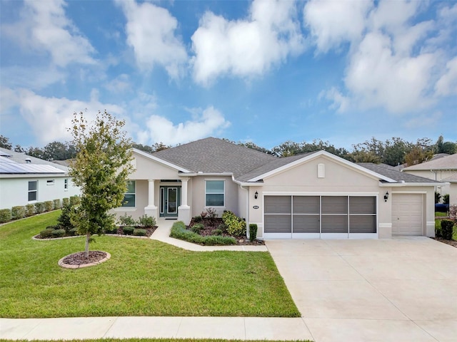 single story home featuring a front lawn and a garage