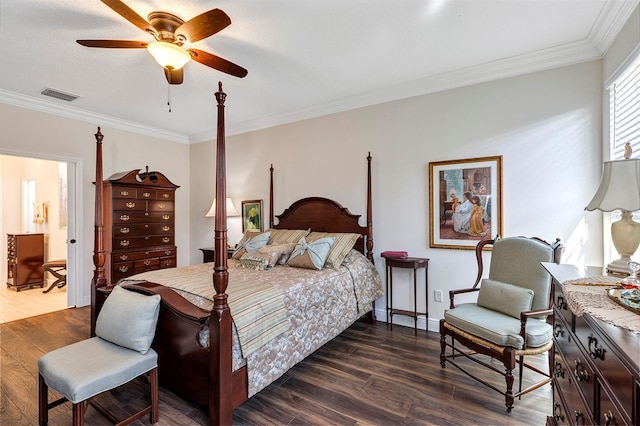 bedroom featuring ensuite bath, dark wood-type flooring, ceiling fan, and crown molding