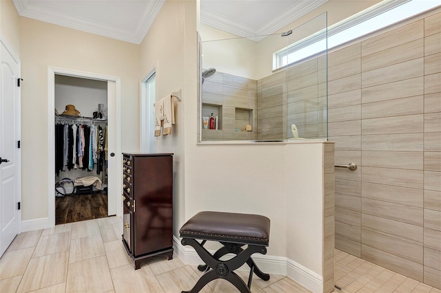 bathroom with crown molding, hardwood / wood-style flooring, and a tile shower