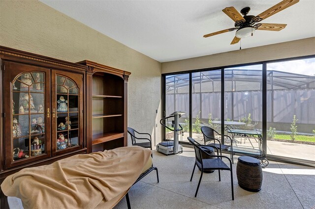 sunroom / solarium featuring a wealth of natural light and ceiling fan