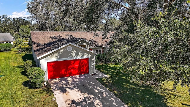 exterior space featuring an outdoor structure, a garage, and a front lawn