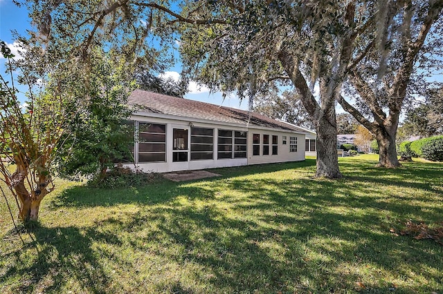 exterior space with a yard and a sunroom