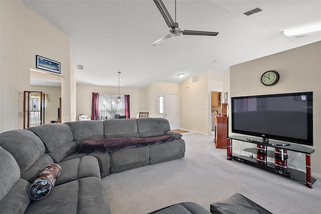 living room featuring lofted ceiling, light colored carpet, and ceiling fan