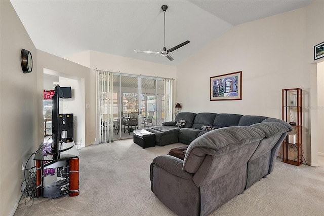 carpeted living room with ceiling fan and vaulted ceiling