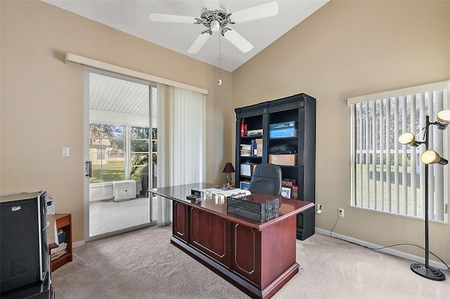 carpeted home office with vaulted ceiling and ceiling fan