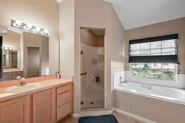 bathroom featuring vanity, vaulted ceiling, tile patterned flooring, and plus walk in shower