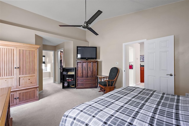 bedroom featuring connected bathroom, light colored carpet, a closet, and ceiling fan