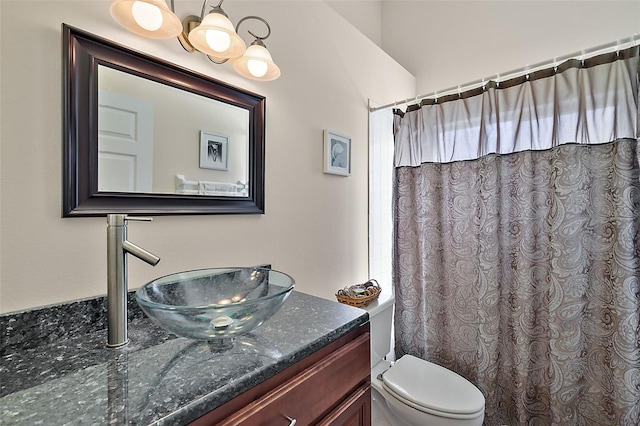 bathroom with vanity, toilet, vaulted ceiling, and curtained shower