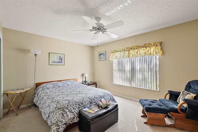 bedroom featuring ceiling fan, a textured ceiling, and carpet floors