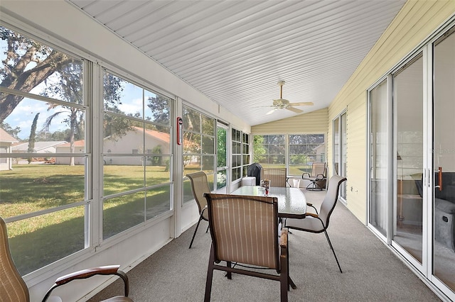 sunroom featuring lofted ceiling, a healthy amount of sunlight, and ceiling fan