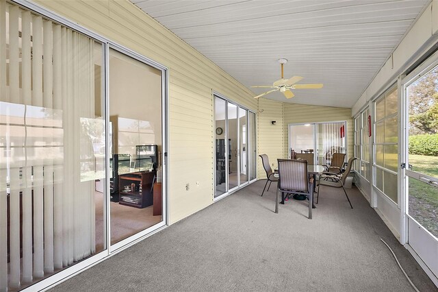 sunroom / solarium with lofted ceiling and ceiling fan