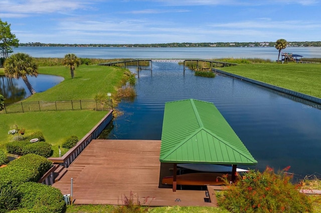 view of dock featuring a yard and a water view