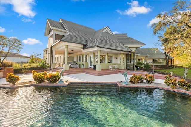 17601 Sawgrass Run, Tavares, FL 32778 - back of house featuring a patio area, ceiling fan, stucco siding, and an outdoor pool