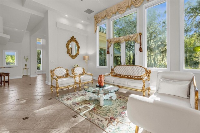 17601 Sawgrass Run, Tavares, FL 32778 - tiled living area with baseboards, a towering ceiling, and recessed lighting