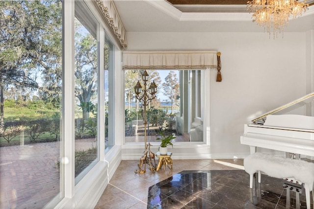 17601 Sawgrass Run, Tavares, FL 32778 - sitting room featuring a chandelier, baseboards, ornamental molding, and a tray ceiling