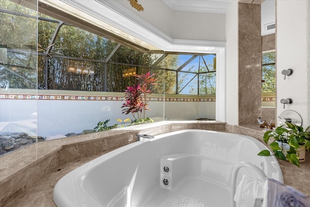 bathroom with ornamental molding and tiled bath