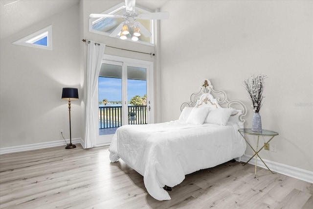 bedroom featuring light wood-type flooring, high vaulted ceiling, access to outside, and ceiling fan