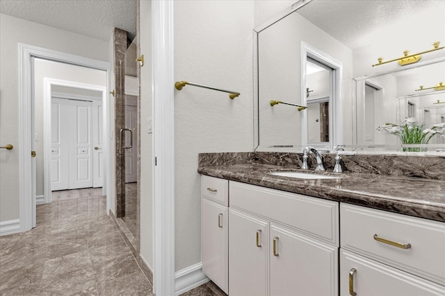 17601 Sawgrass Run, Tavares, FL 32778 - bathroom featuring a textured ceiling, a shower stall, vanity, and baseboards
