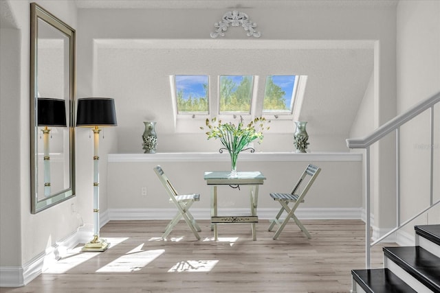 17601 Sawgrass Run, Tavares, FL 32778 - sitting room featuring light wood-type flooring, stairway, and baseboards