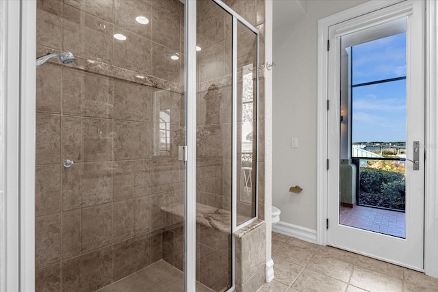 17601 Sawgrass Run, Tavares, FL 32778 - full bath featuring a shower stall, toilet, tile patterned flooring, and baseboards