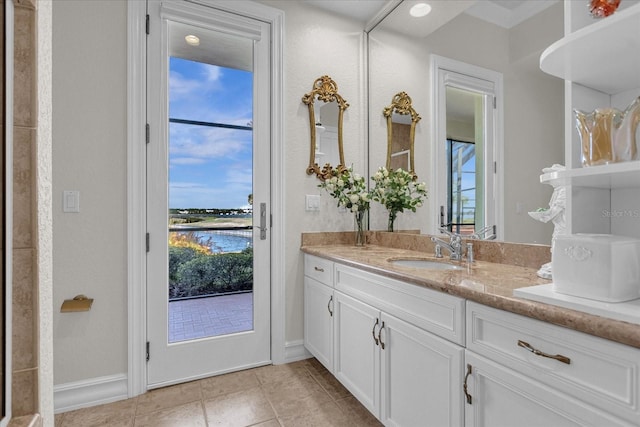 bathroom with vanity, a water view, and tile patterned flooring