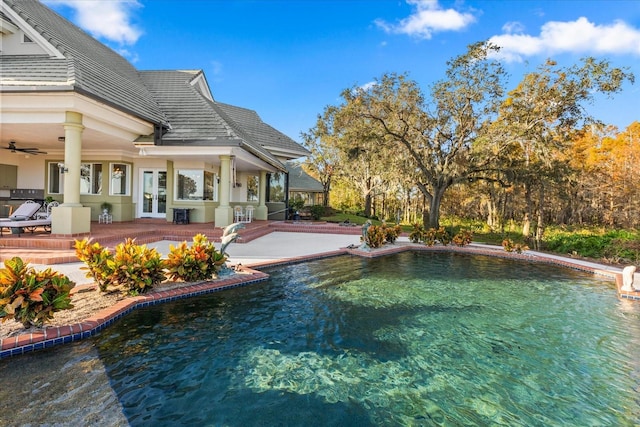 view of swimming pool with french doors and a patio