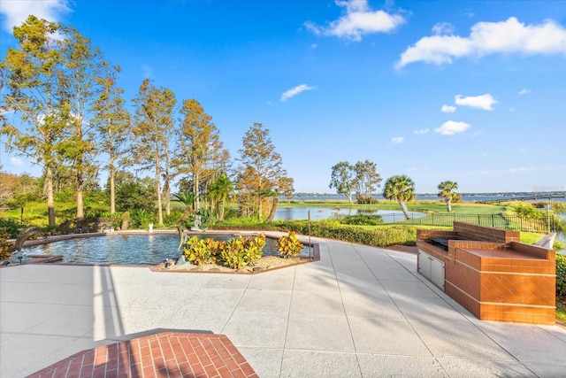 17601 Sawgrass Run, Tavares, FL 32778 - view of property's community featuring a water view, a swimming pool, fence, and a patio