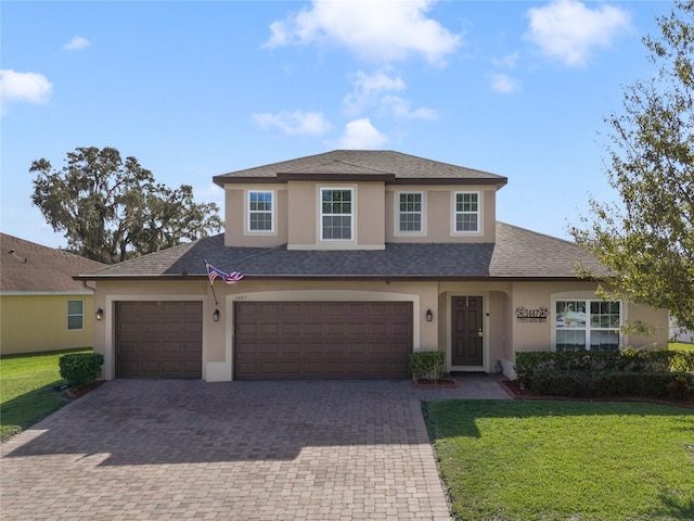 view of front of property with a front yard and a garage