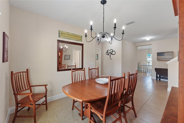 dining space featuring light tile patterned floors, visible vents, and baseboards