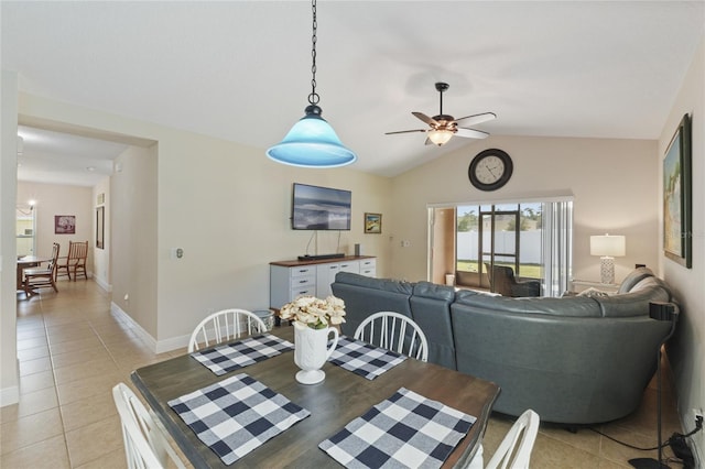 dining room with lofted ceiling, baseboards, a ceiling fan, and light tile patterned flooring