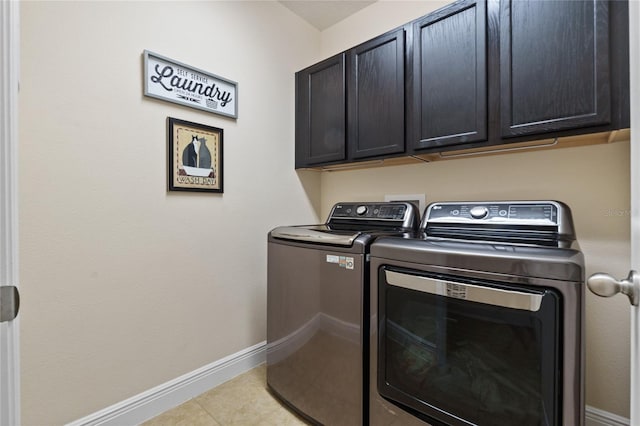 laundry area featuring cabinet space, baseboards, and separate washer and dryer