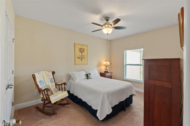 carpeted bedroom with a ceiling fan and baseboards