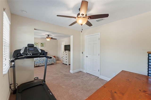 workout room featuring light carpet, visible vents, and baseboards