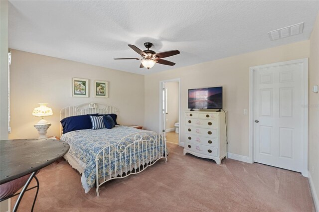 bedroom featuring visible vents, carpet flooring, ceiling fan, a textured ceiling, and baseboards