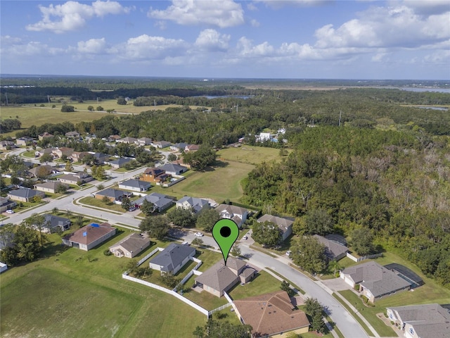 drone / aerial view with a residential view and a forest view