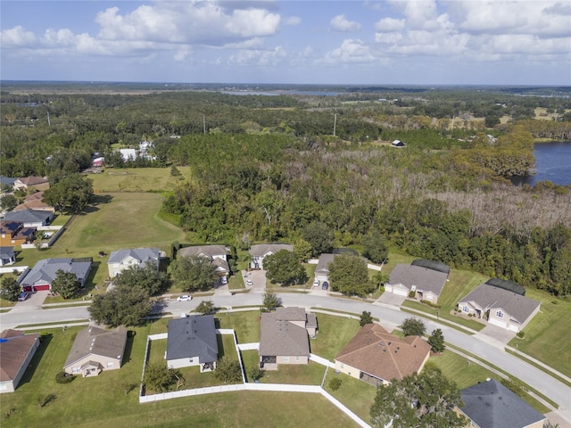 bird's eye view featuring a water view, a wooded view, and a residential view