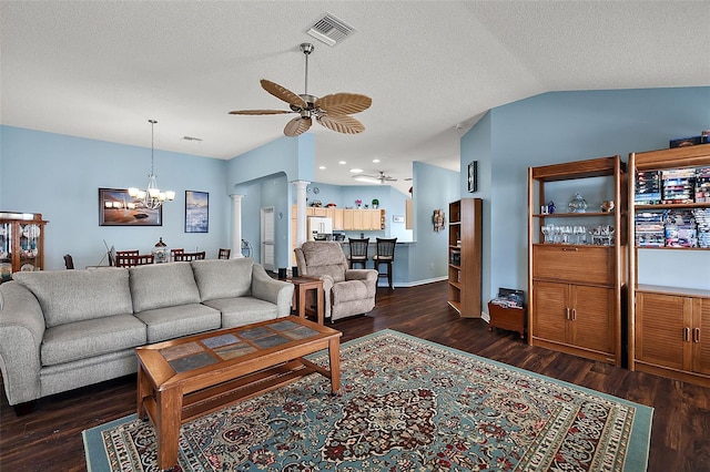 living room with decorative columns, ceiling fan with notable chandelier, and dark hardwood / wood-style flooring