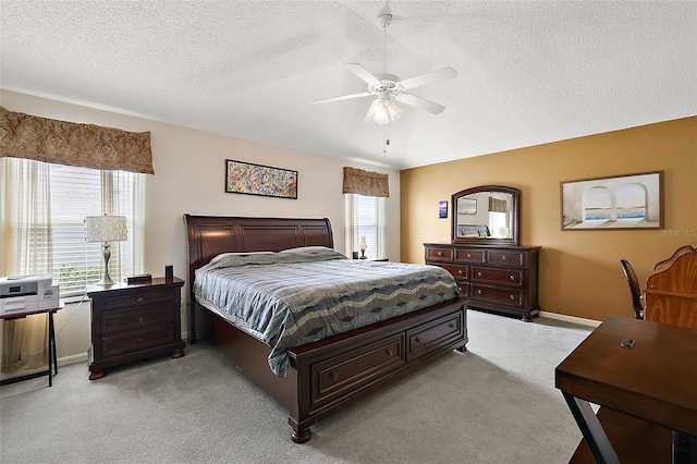 carpeted bedroom featuring a textured ceiling and ceiling fan