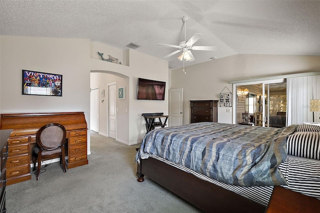 carpeted bedroom featuring vaulted ceiling, a textured ceiling, access to outside, and ceiling fan