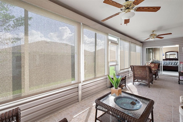 sunroom / solarium featuring ceiling fan