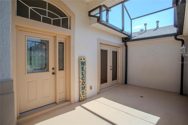 entrance to property featuring a patio area