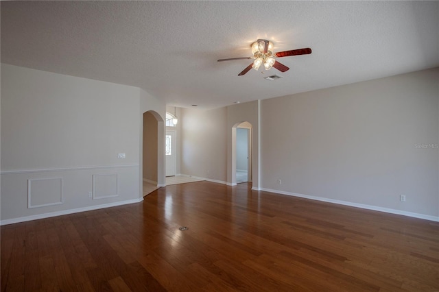 spare room with a textured ceiling, wood-type flooring, and ceiling fan