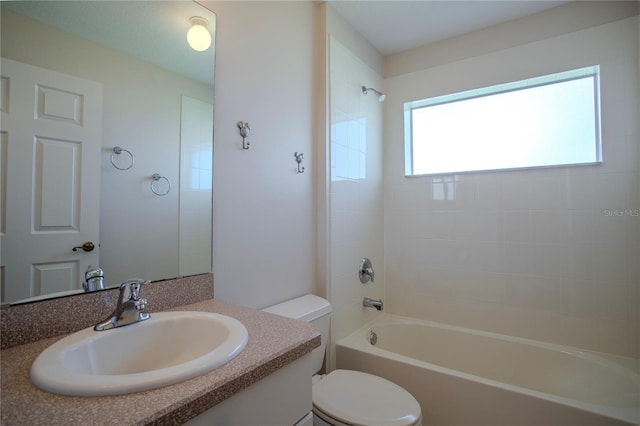 full bathroom with vanity, toilet, and tiled shower / bath combo