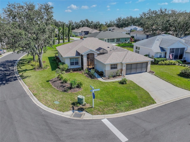 view of front of property featuring a garage and a front lawn