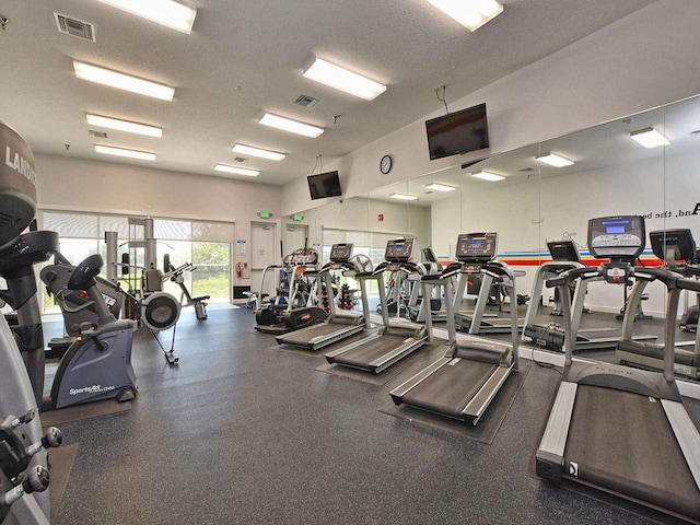 exercise room with a textured ceiling