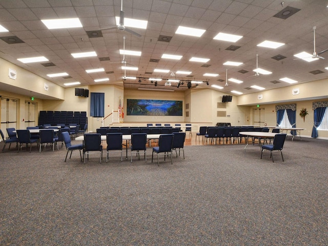 interior space with carpet flooring and a paneled ceiling