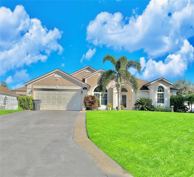 view of front of house with a front lawn and a garage