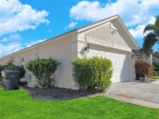 view of side of property featuring a yard and a garage