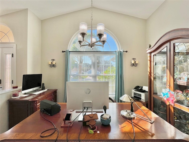 office area with lofted ceiling and a chandelier